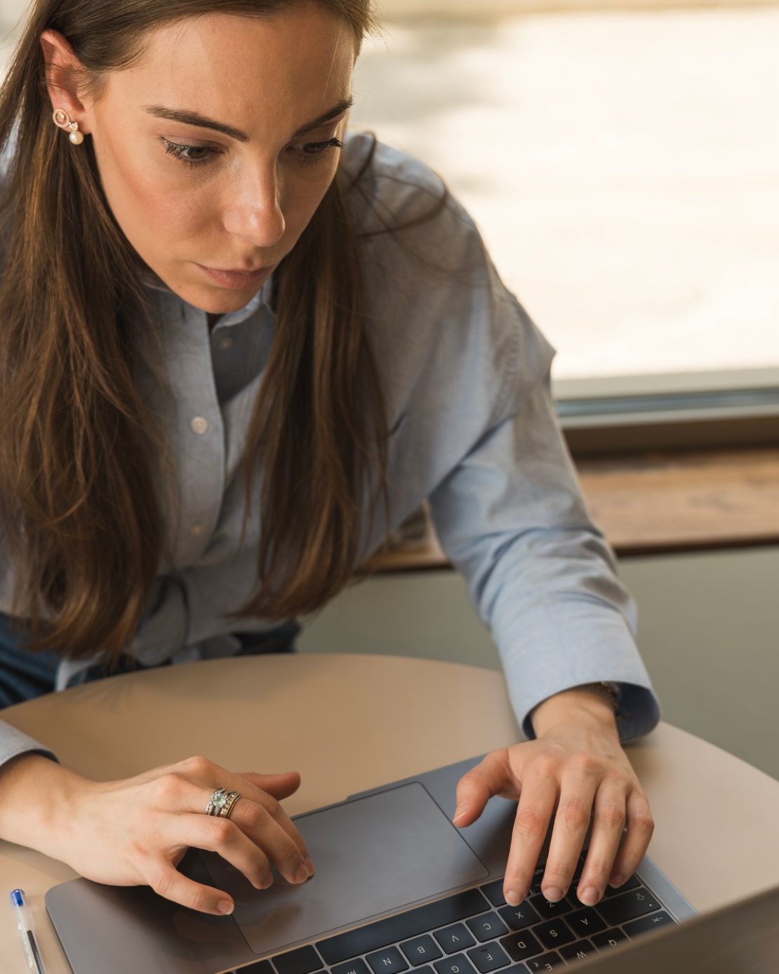 Close-up of a formal dressed corporate woman working in the office with her laptop