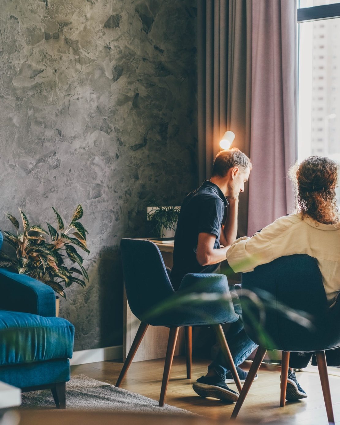 Family of middle aged man and woman at work together on project